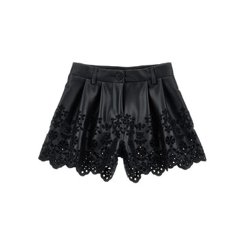 Shorts in ecopelle con ricamo floreale traforato