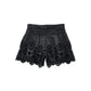 Shorts in ecopelle con ricamo floreale traforato