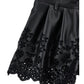 Shorts in ecopelle con ricamo floreale traforato
